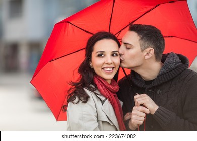 Couple in love under red umbrella. - Powered by Shutterstock