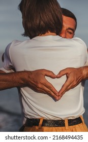 Couple In Love Walking On The Beach. Family. Diverse Couple On Summer Vacation.Portrait Beautiful Healthy Young Adults Girlfriend And Boyfriend Hugging Happy.