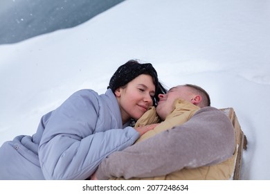 A Couple In Love Walks On The Shore Of The Winter Sea, A Man And A Woman Are Frozen, It Is Snowing