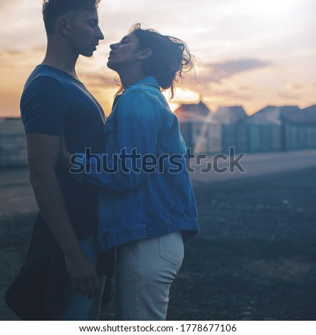 Couple in love watching sunset together. Love concept. Couple. Man and woman sunset. 