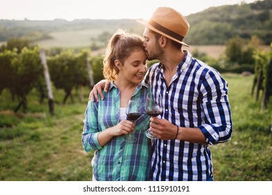 Couple in love working at winemaker vineyard - Powered by Shutterstock