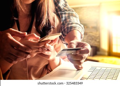 A Couple Lover Using Smart Phone And Holding Cedit Card For Shopping Online