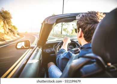 Couple of lovers driving on a convertible car - Newlywed pair on a romantic date - Shutterstock ID 551199679