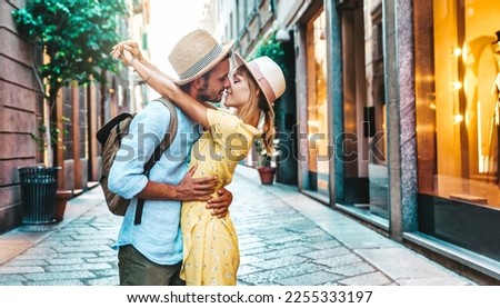 Couple of lovers kissing on city street - Two tourists enjoying romantic vacation together - Boyfriend and girlfriend dating outside - Love, tourism and life style concept