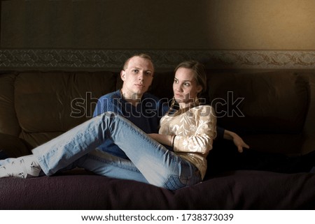 Similar – Joyful couple laughing together on a vintage sofa