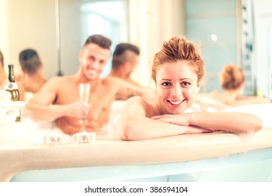 Couple of lovers relaxing in a jacuzzi full of foam - Partners celebrating anniversary in a luxury spa resort