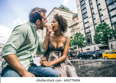 Couple Of Lovers Sharing A Hot Dog Outdoors