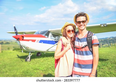 Couple Of Lovers Taking A Charter Airplane - Tourists On Vacation Waiting Their Flight To Go On Excursion - People Smiling And Private Plane On Background