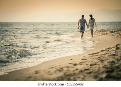 Couple Lovers Walking On The Beach