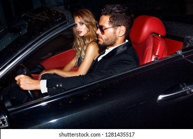 Couple In Luxury Car. Night Life.