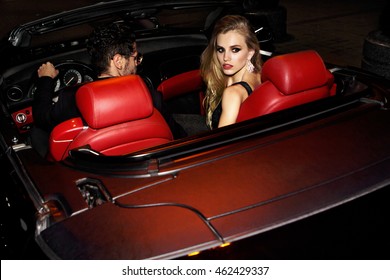 Couple In Luxury Car. Night Life.