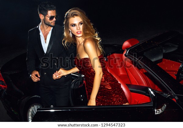 Couple in luxury car. Night\
life.