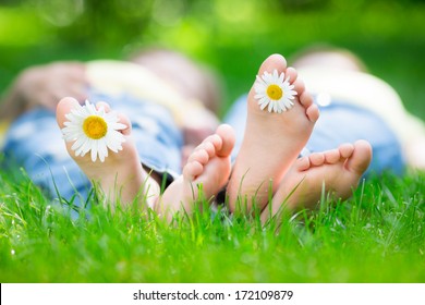 Couple Lying On Grass Outdoors In Spring Park