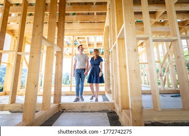 Couple make their dreams of building their own home come true visiting house under construction - Shutterstock ID 1772742275