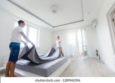 A couple making bed