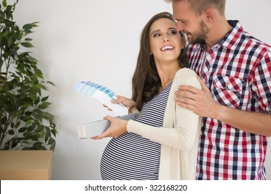 Couple Making Decision About Baby's Room Color