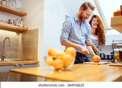 Couple making fresh organic juice in kitchen together - Powered by Shutterstock