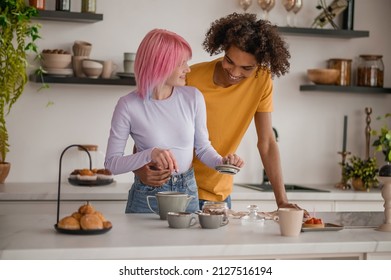 A Couple Making Tea In The Kitchen