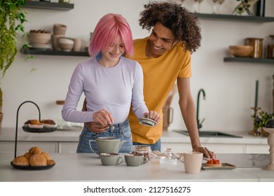 A Couple Making Tea In The Kitchen