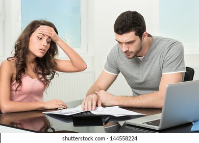 Couple, Man Angry And Upset After Looking At Credit Card Statement.