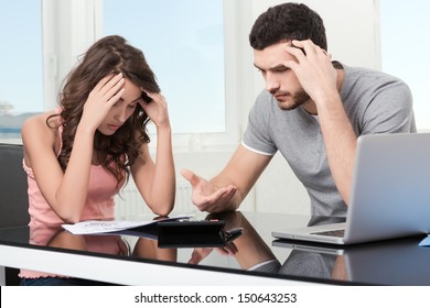 Couple, Man Angry And Upset After Looking At Credit Card Statement.