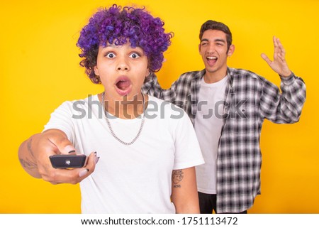 couple of man and woman arguing isolated with the television remote
