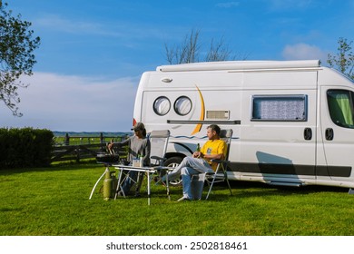 couple of man and woman bbq outside a camper van RV at Texel, where you are surrounded by the stunning beauty of nature and the lovely beach vibes of the Netherlands, motorhome at the farm - Powered by Shutterstock