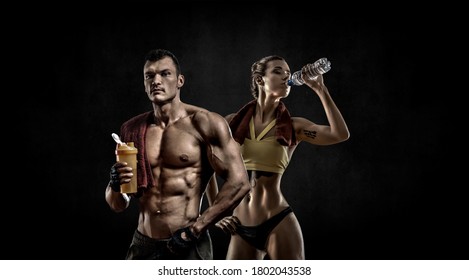 Couple Man With Woman Bodybuilders Hold Shaker With Sportive Nutrition - Protein Of Shaker On Black Background With Empty Space For Text. Gym Concept