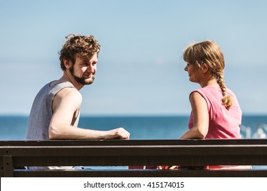 Couple Man And Woman Dating By Sea Ocean Outdoor. Young Girl And Guy Sitting On Bench. Summer Love.