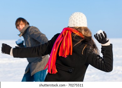 Couple - Man And Woman - Having A Snowball Fight In Winter