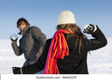 Couple - Man And Woman - Having A Winter Walk And Having A Snowball Fight