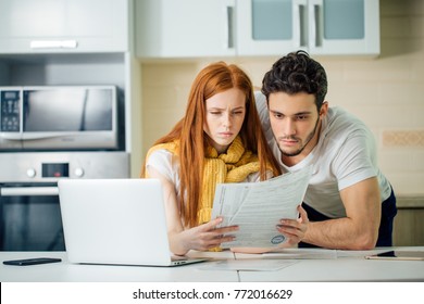 Couple Managing Finances, Reviewing Their Bank Accounts Using Laptop Computer To Paying Taxes Online