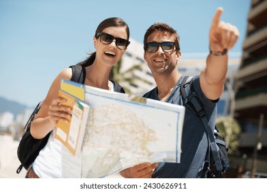 Couple, map and search with pointing on vacation, street and excited for giving direction. Woman, man and chart for location, landmark and travel for memory with buildings, ocean or nature in Italy