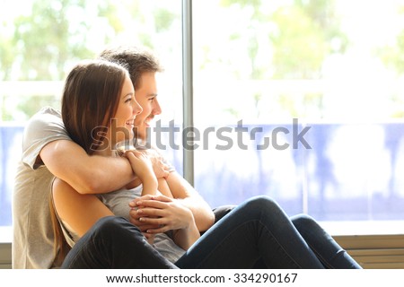 Couple or marriage in his new home looking through the window