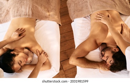 Couple massage with aroma oil, top view. Beautiful couple spend time together and enjoying romance massage, spa resort