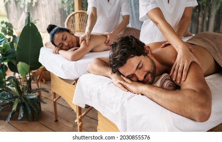 Couple massage at spa resort. Beautiful couple getting a back massage outdoor, romantic weekend and relax