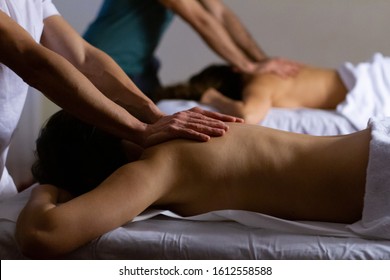 Couple Massage. Two Men Doing Back Massage To Two Women. Close Up Shot. Shallow Depth Of Field. Low Key Light