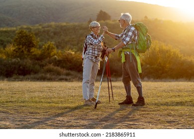 Couple Of Mature Hikers Talking At The Field At The End Of Day