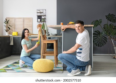 Couple with measuring tapes in kitchen - Powered by Shutterstock