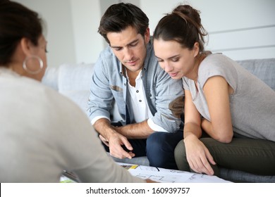 Couple meeting architect for house construction