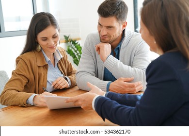 Couple Meeting Financial Adviser For Home Investment Contract