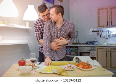 Couple Of Men Gay Flirts Each Other Cooking A Pizza Together And Drinking A Wine.