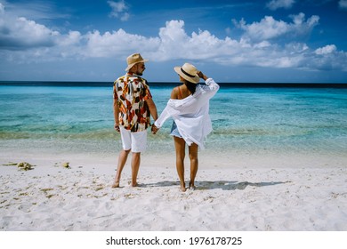 couple of men and woman mid age on the beach of Curacao, Grote Knip beach Curacao Dutch Antilles Caribbean. on a tropcial beach with white sand