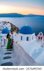 Couple Men And Woman On Vacation Santorini Greece. Young Couple On Vacation In Greece