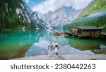 A couple of men and woman visit Braies Lake Lago di Braies Italian Dolomites alpine lake Italy, Europe, men, and women visit Lago Di Braies during vacation summer holiday