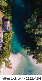 A Couple Of Men And Women Are Kayaking In The Rainforest Of Koh Chang Thailand Tropical Island. Drone View From Above At The Rainforest With Couple In Kayak At Tropical White Beach With Palm Trees