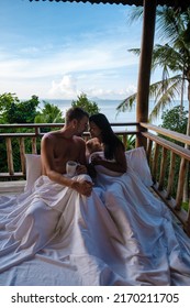 A Couple Of Men And Women On The Balcony Of A Beach Hut With Coffee In Railay Beach Krabi Thailand In The Morning, Men And Woman Waking Up In A Backpacker Hut In Thailand