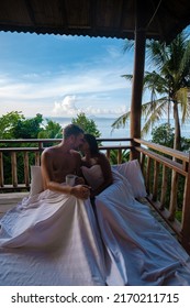 A Couple Of Men And Women On The Balcony Of A Beach Hut With Coffee In Railay Beach Krabi Thailand In The Morning, Men And Woman Waking Up In A Backpacker Hut In Thailand