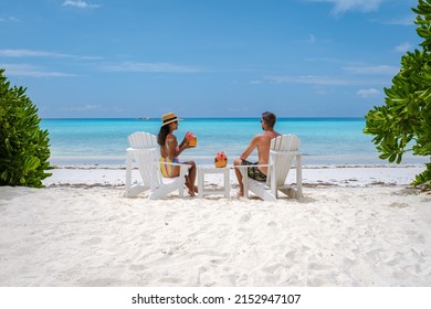 couple men and women on the beach with coconut drink Praslin Seychelles tropical island with withe beaches and palm trees, the beach of Anse Volbert Seychelles. 