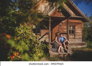 Couple Men And Women In The Village, Near A Wooden House. Country Style. Rustic Summer